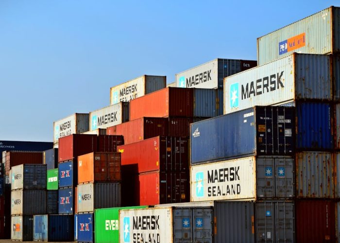 Colorful stacked shipping containers at a port exemplify global logistics.